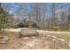 Home exterior with front yard seating area, surrounded by mature trees at 3341 Camelot Way, Loganville, GA 30052