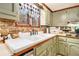 Charming kitchen with stone backsplash, double-basin sink, and decorative window valance at 3341 Camelot Way, Loganville, GA 30052