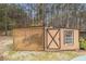 Small storage shed with a window and lattice paneling at 3341 Camelot Way, Loganville, GA 30052