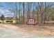Charming red and white barn in the back yard with a gravel area at 3341 Camelot Way, Loganville, GA 30052