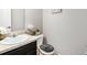 Cozy half bathroom features a pedestal sink and toilet with neutral walls and simple decor at 3956 Church View Ln, Suwanee, GA 30024