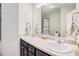 Bathroom with double sinks, large mirror, vanity and combined tub and shower at 3956 Church View Ln, Suwanee, GA 30024