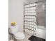 Cozy bathroom with toilet, shower and tub combination, and shower curtain at 3956 Church View Ln, Suwanee, GA 30024