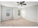 Neutral bedroom boasts two windows and plush carpet at 3956 Church View Ln, Suwanee, GA 30024