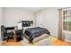 Cozy bedroom with hardwood flooring, desk, neutral walls, and natural light at 3956 Church View Ln, Suwanee, GA 30024