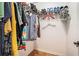 Organized walk in closet with clothing racks and shelving for shoes at 3956 Church View Ln, Suwanee, GA 30024