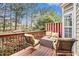 Outdoor deck with wood railing and outdoor seating surrounded by lush trees at 3956 Church View Ln, Suwanee, GA 30024