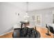 Cozy dining area with a table, chairs, bench, and view of the backyard at 3956 Church View Ln, Suwanee, GA 30024