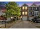 Attractive townhome exterior with stone accents, a one car garage, and well-manicured landscaping at 3956 Church View Ln, Suwanee, GA 30024