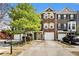Attractive townhome exterior with stone accents, a one car garage, and well-manicured landscaping at 3956 Church View Ln, Suwanee, GA 30024