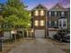 Attractive townhome exterior with stone accents, a one car garage, and well-manicured landscaping at 3956 Church View Ln, Suwanee, GA 30024