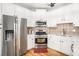 Bright and updated kitchen with stainless steel appliances and white cabinetry at 3956 Church View Ln, Suwanee, GA 30024