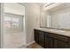 Bathroom with dual sinks and view of bedroom at 11973 Lovejoy Crossing Way, Hampton, GA 30228