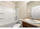 Bathroom with vanity and tiled bathtub at 11973 Lovejoy Crossing Way, Hampton, GA 30228