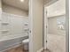 View of a bathroom with a shower and toilet, leading to a carpeted bedroom at 11973 Lovejoy Crossing Way, Hampton, GA 30228