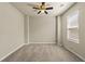 Large bedroom with neutral walls and carpet, ceiling fan, and plenty of natural light at 11973 Lovejoy Crossing Way, Hampton, GA 30228