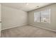 Bedroom with neutral carpet and large window offering plenty of natural light at 11973 Lovejoy Crossing Way, Hampton, GA 30228