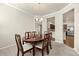 Dining room with chandelier and view of kitchen at 11973 Lovejoy Crossing Way, Hampton, GA 30228