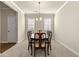 Dining room with carpet, traditional furniture, and a pendant light fixture at 11973 Lovejoy Crossing Way, Hampton, GA 30228