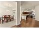 Open-concept kitchen with dark wood cabinets, stainless steel appliances, and granite countertops at 11973 Lovejoy Crossing Way, Hampton, GA 30228