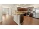 Open kitchen layout with stainless appliances, a center island, and dark cabinetry at 11973 Lovejoy Crossing Way, Hampton, GA 30228