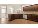 Open kitchen with granite countertops, stainless steel appliances, and hardwood floors at 11973 Lovejoy Crossing Way, Hampton, GA 30228