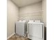 A laundry room with full size washer and dryer and shelving at 11973 Lovejoy Crossing Way, Hampton, GA 30228