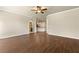 Spacious living room featuring hardwood floors leading to a kitchen at 11973 Lovejoy Crossing Way, Hampton, GA 30228