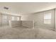 A large loft with carpeted flooring and lots of natural light at 11973 Lovejoy Crossing Way, Hampton, GA 30228