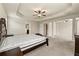 Spacious main bedroom featuring plush carpet, ceiling fan, and natural light from large windows at 11973 Lovejoy Crossing Way, Hampton, GA 30228