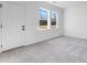 Bright bedroom with natural light from two windows with plush carpeting and a door at 3726 Willingham Sw Run, Marietta, GA 30008