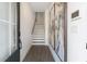 Inviting entryway featuring wood-look floors, stairs, a smart thermostat, and elegant artwork at 3726 Willingham Sw Run, Marietta, GA 30008