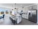 Open kitchen featuring an island with bar seating, modern appliances, and stainless steel refrigerator at 3726 Willingham Sw Run, Marietta, GA 30008