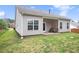 View of the backyard with a patio area, complemented by a well-maintained lawn and vinyl siding at 3804 Hawk Tail Dr, Loganville, GA 30052