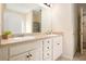 Bathroom with double sink vanity, cream cabinetry, granite countertop, and a framed mirror at 3804 Hawk Tail Dr, Loganville, GA 30052