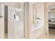 Bright bathroom with a glass-door shower and separate soaking tub with a decorative arched alcove at 3804 Hawk Tail Dr, Loganville, GA 30052