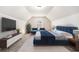 Modern bedroom with blue accents, including a large bed and two armchairs, set against a neutral backdrop at 3804 Hawk Tail Dr, Loganville, GA 30052