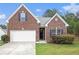 Charming brick home with a two-car garage, manicured lawn, and dark blue shutters at 3804 Hawk Tail Dr, Loganville, GA 30052