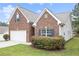 Charming brick home with attached garage and lush landscaping at 3804 Hawk Tail Dr, Loganville, GA 30052