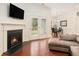 Cozy living room with fireplace and double glass patio doors at 3804 Hawk Tail Dr, Loganville, GA 30052