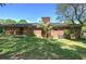 The brick house has a well-manicured lawn, a brick chimney, and mature trees that provide plenty of shade at 4361 Stanley Dr, Powder Springs, GA 30127