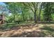 Mature trees and a well-manicured lawn surround the home's exterior, creating a peaceful and private setting at 4361 Stanley Dr, Powder Springs, GA 30127