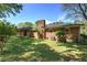 The brick house has a well-manicured lawn, a brick chimney, and mature trees that provide plenty of shade at 4361 Stanley Dr, Powder Springs, GA 30127