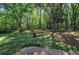 Mature trees and a well-manicured lawn surround the home's exterior, creating a peaceful and private setting at 4361 Stanley Dr, Powder Springs, GA 30127
