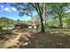 Mature trees and a well-manicured lawn surround the home's exterior, creating a peaceful and private setting at 4361 Stanley Dr, Powder Springs, GA 30127