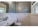Bathroom featuring a tiled backsplash, neutral wall paint, window and under-sink cabinet at 4361 Stanley Dr, Powder Springs, GA 30127