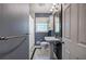 Bathroom featuring a pedestal sink, tiled floor, and a window, showcasing a clean and functional design at 4361 Stanley Dr, Powder Springs, GA 30127