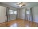 Bedroom with hardwood floors, a ceiling fan and two windows that let in natural light for a relaxing atmosphere at 4361 Stanley Dr, Powder Springs, GA 30127