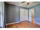 This bedroom features hardwood floors, a ceiling fan, and a closet with sliding doors at 4361 Stanley Dr, Powder Springs, GA 30127