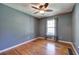 Bedroom featuring hardwood floors, neutral wall paint, and a window that provides a bright and airy atmosphere at 4361 Stanley Dr, Powder Springs, GA 30127